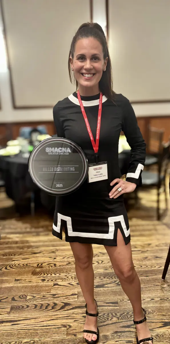 Nikki Liddy holding a SMACNA Greater Chicago 2025 plaque made out to Hillco Distributing
