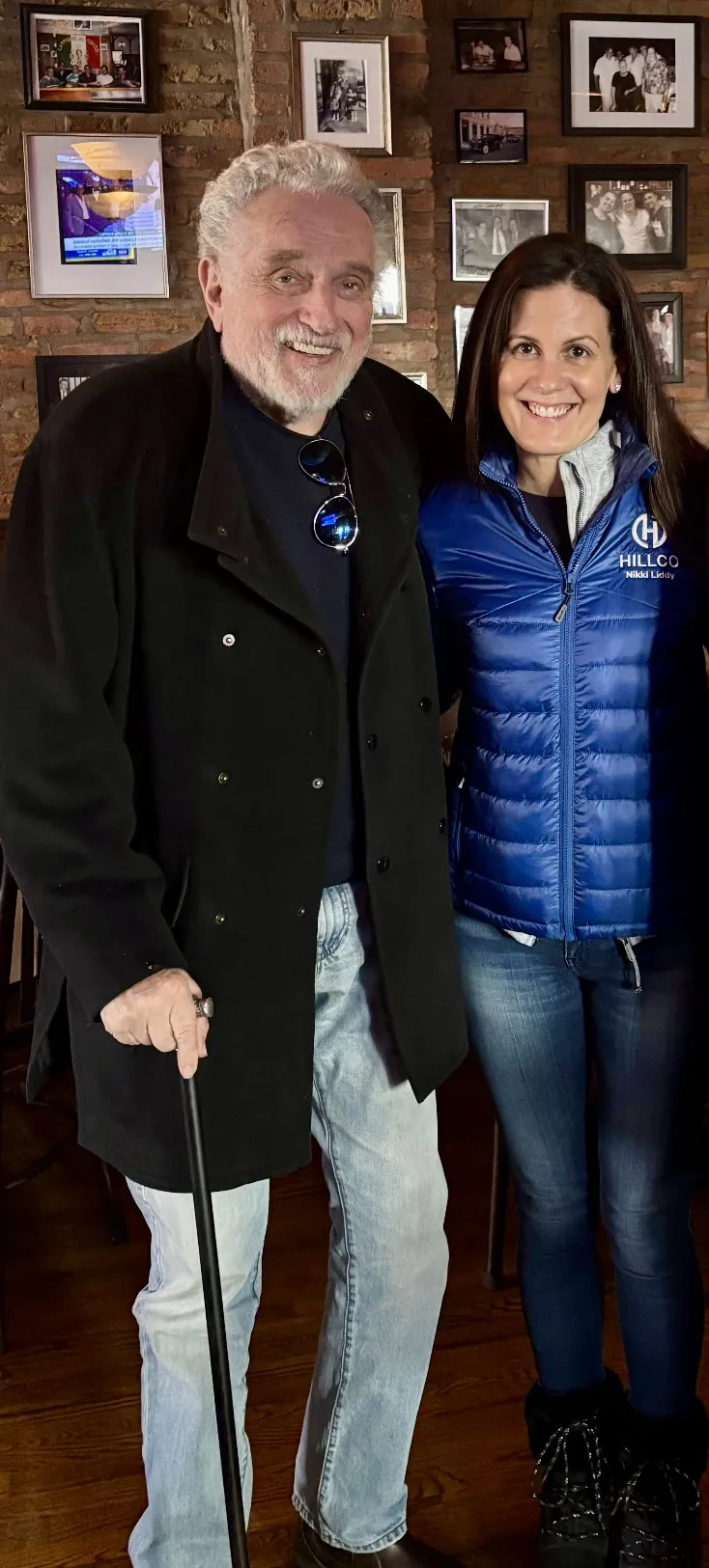 Ron Hillman, founder of Hillco Distributing, and Nikki Liddy in a blue Hillco vest, standing together and smiling